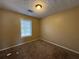 A cozy bedroom features neutral walls, carpet flooring and natural light from the window at 904 Crossing Rock Dr, Lawrenceville, GA 30043