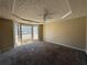 Large bedroom with a ceiling fan and carpeted floors and a large bay window at 904 Crossing Rock Dr, Lawrenceville, GA 30043