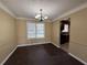 Cozy dining room with wood floors, chandelier, and a view into the kitchen at 904 Crossing Rock Dr, Lawrenceville, GA 30043