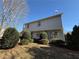 Charming home exterior featuring light siding, well-manicured landscaping, and a clear blue sky at 904 Crossing Rock Dr, Lawrenceville, GA 30043