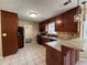 Eat-in kitchen features granite countertops, wood cabinets, tile floors, and modern lighting at 904 Crossing Rock Dr, Lawrenceville, GA 30043