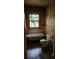 Shows a bathroom featuring old fixtures and peeling paint, highlighting the need for renovation at 1687 Neely Ave, Atlanta, GA 30344