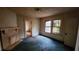 Bedroom with a brick fireplace, an old door, and a window, ready for renovation at 1687 Neely Ave, Atlanta, GA 30344