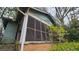 View of the home's exterior featuring a screened porch and weathered facade at 1687 Neely Ave, Atlanta, GA 30344