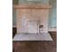 Brick fireplace with a white mantel and a blank firebox requiring updates at 1687 Neely Ave, Atlanta, GA 30344