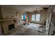 The interior of a dilapidated living room, reveals peeling paint and debris-covered floors at 1687 Neely Ave, Atlanta, GA 30344