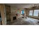 Living room with a brick fireplace and peeling paint at 1687 Neely Ave, Atlanta, GA 30344