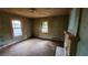 Green-painted living room featuring natural light from windows and a brick fireplace at 1687 Neely Ave, Atlanta, GA 30344