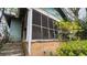 Features the exterior of a sunroom needing repair, with aged brick and overgrown plants at 1687 Neely Ave, Atlanta, GA 30344