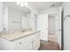 Bathroom with a large vanity with granite countertop, wood look tile flooring, and neutral color palette at 2019 Wyndham Pl, Conyers, GA 30013