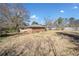 Rear view of property with well maintained back yard and mature trees at 3606 Trickum Ne Rd, Marietta, GA 30066