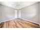 Well-lit bedroom with fan, neutral walls, and wood-look floors at 3606 Trickum Ne Rd, Marietta, GA 30066