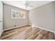 Bright bedroom featuring a window view and modern ceiling fan at 3606 Trickum Ne Rd, Marietta, GA 30066