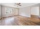 Bright living room featuring large windows, light colored walls, modern flooring and a classic ceiling fan at 3606 Trickum Ne Rd, Marietta, GA 30066