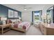 Charming bedroom with blue accent wall, ample natural light, and tasteful decor at 6094 Marigold Way, Atlanta, GA 30349