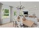 Stylish dining area open to living room with modern light fixture and ample natural light at 6094 Marigold Way, Atlanta, GA 30349