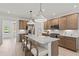 Open kitchen featuring a large island with seating, stainless steel appliances, and modern pendant lighting at 6094 Marigold Way, Atlanta, GA 30349