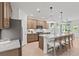 Open kitchen featuring a large island with seating, stainless steel appliances, and modern pendant lighting at 6094 Marigold Way, Atlanta, GA 30349