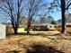 Large fenced backyard with mature trees and storage shed provides ample space at 2257 Collins Dr, East Point, GA 30344