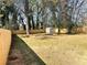 Fenced backyard featuring a grassy lawn and mature trees at 2257 Collins Dr, East Point, GA 30344