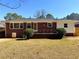 View of the home's exterior and backyard with grass and a short brick porch at 2257 Collins Dr, East Point, GA 30344