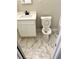 Bathroom featuring white vanity and toilet over marble tile floors at 2257 Collins Dr, East Point, GA 30344