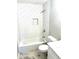 Bathroom with white subway tile, shower niche, marble floors, and updated fixtures at 2257 Collins Dr, East Point, GA 30344