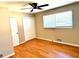 Bright bedroom featuring hardwood floors, fan, and a large window at 2257 Collins Dr, East Point, GA 30344