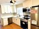 Modern kitchen featuring stainless steel appliances, quartz countertops, and hardwood floors at 2257 Collins Dr, East Point, GA 30344