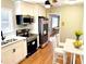 Well-lit kitchen with stainless steel appliances, wood floors, and a breakfast nook at 2257 Collins Dr, East Point, GA 30344