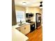 Well-lit kitchen with stainless steel appliances, quartz countertops, and white cabinetry at 2257 Collins Dr, East Point, GA 30344