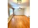 Open-concept living space with hardwood floors, a ceiling fan, and large windows at 2257 Collins Dr, East Point, GA 30344