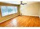 Bright living room with hardwood floors, ample natural light, and a ceiling fan at 2257 Collins Dr, East Point, GA 30344