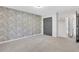 Spacious bedroom with stylish accent wall, carpet, and modern ceiling fan at 3242 Kingswood Gln, Decatur, GA 30034