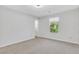Empty bedroom with carpeted floor, white walls, and a bright window at 3242 Kingswood Gln, Decatur, GA 30034