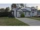 Side view of the home showing a long driveway and neutral siding with dark trim on the exterior at 3242 Kingswood Gln, Decatur, GA 30034