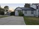 The side of the house shows neutral siding with dark trim and a long cracked driveway at 3242 Kingswood Gln, Decatur, GA 30034