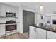 Modern eat-in kitchen features stainless steel appliances, granite counters, and gray cabinets at 3242 Kingswood Gln, Decatur, GA 30034