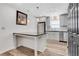 Bright kitchen with island, stainless steel appliances, and wood flooring at 3242 Kingswood Gln, Decatur, GA 30034