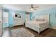 Light blue bedroom with a white bed, a large dresser, and natural light at 3277 Aberrone Pl, Buford, GA 30519