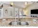 Close up of a kitchen sink featuring stainless steel fixtures and granite countertops at 3277 Aberrone Pl, Buford, GA 30519