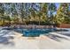 A luxurious backyard pool features a stone waterfall and lush landscaping, creating a private oasis at 3277 Aberrone Pl, Buford, GA 30519