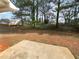 Large backyard with mature trees and patio at 4200 Flakes Mill Manor Ln, Ellenwood, GA 30294