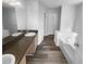 This bathroom features a double sink vanity and a bright white soaking tub at 4200 Flakes Mill Manor Ln, Ellenwood, GA 30294