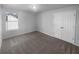 This bedroom features neutral carpet and a large double door closet at 4200 Flakes Mill Manor Ln, Ellenwood, GA 30294