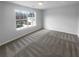 Cozy bedroom with large window and plush carpeting at 4200 Flakes Mill Manor Ln, Ellenwood, GA 30294