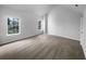 Bright bedroom with carpeted flooring and natural light from two large windows at 4200 Flakes Mill Manor Ln, Ellenwood, GA 30294