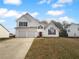 Charming two-story home featuring a two-car garage and landscaped front yard at 4200 Flakes Mill Manor Ln, Ellenwood, GA 30294