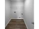 Laundry room with storage shelf, wood-look flooring, ready for your washer and dryer at 4200 Flakes Mill Manor Ln, Ellenwood, GA 30294