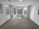 Living room with large bay window, neutral colors, and ample natural light at 4200 Flakes Mill Manor Ln, Ellenwood, GA 30294